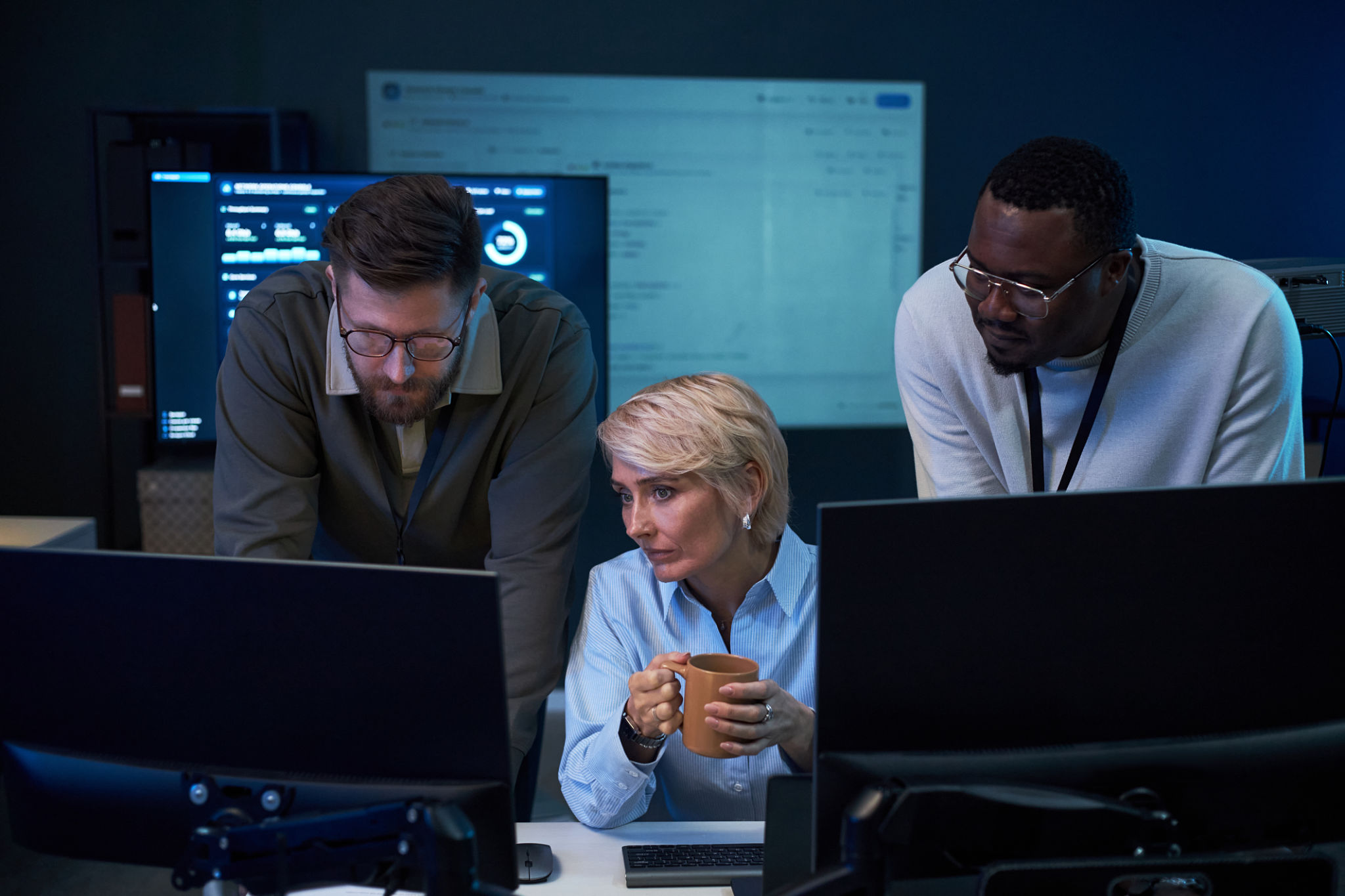 Engineering team monitoring industrial systems in a control room