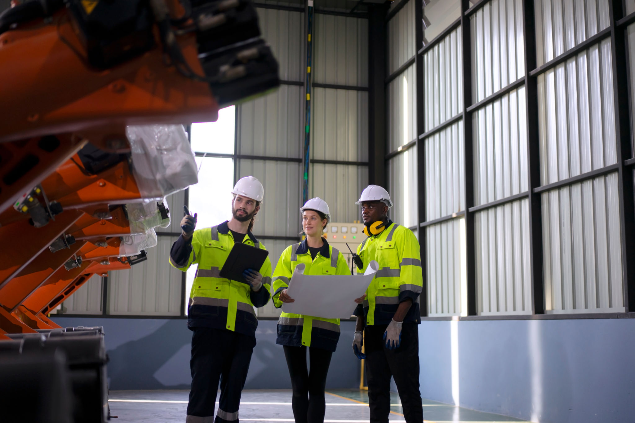 Engineer working with robotic automation in a modern factory